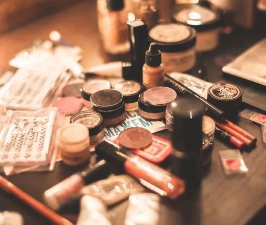 Professional beauty salon cosmetics including foundation, lipstick and brushes